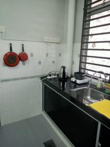 a kitchen with a sink and a counter top at D'Mentari Laguna Super Seaview in Port Dickson