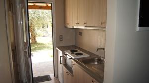 a small kitchen with a sink and a stove at Villa Rododafni in Roda