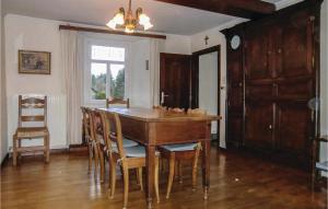 a dining room with a wooden table and chairs at Holiday Home Braunlauf 03 in Braunlauf