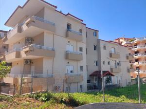 un edificio de apartamentos con balcones en un lateral en Eleni's Apartments Igoumenitsa -- Γκαρσονιέρα 1ου ορόφου επιπλωμένη, εξοπλισμένη, en Igoumenitsa