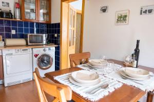 a kitchen with a table with plates and dishes on it at Sarah´s apartment Bratislava in Bratislava