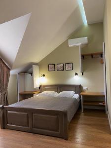 a bedroom with a bed in a room with an attic at Gosudar Hotel in Kropyvnytskyi