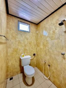 a bathroom with a toilet and a shower and a window at Kangar Hotel Sdn Bhd in Kangar