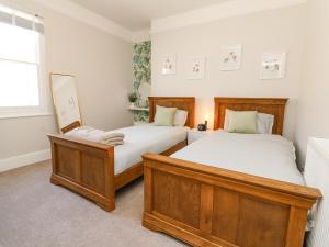 a bedroom with two beds and a window at Myrtle House in Ilfracombe