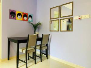 a dining room table with two chairs and two mirrors at Pali Carters Building 101, 20th Road, Khar West by Connekt Homes in Mumbai