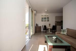 a living room with a couch and a table at Costas Apartments in Polis Chrysochous