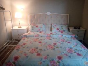 a bedroom with a large bed with flowers on it at Private Room in shared Apartment in Abu Dhabi