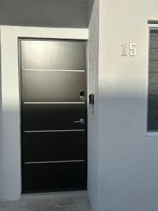 a black door in a room with the number at Cancun15 3 Bedrooms with private Bathrooms 15 min Airport 20 min Beach in Cancún