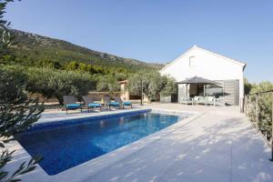 a villa with a swimming pool and a house at Villa Sole with Private Pool in Kaštela