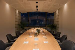 a large conference room with a long table and chairs at Dar Al Mauge Boutique Hotel with Outdoor Pool in Bethlehem