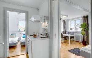 a white apartment with a kitchen and a living room at Villa Gertrud in Kolding