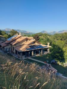 a house with a roof on top of a hill at BnB Bagno di Bosco in Gubbio