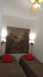 a bedroom with two beds and a painting on the wall at Hendaye plage, Résidence Eskualduna A in Hendaye