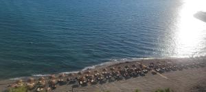a group of people on the beach near the water at Amfora apartments in Lezhë