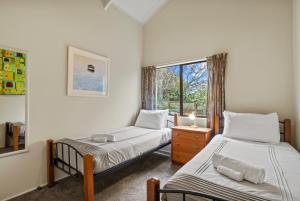 a bedroom with two beds and a window at Greenhaven with wi-fi in Taupo