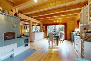 a kitchen and dining room with a table in a cabin at Zrub Tatranský in Stará Lesná