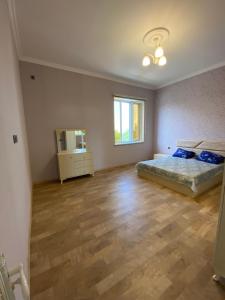a bedroom with a bed and a television in it at Dreamed Villa In Gabala in Gabala