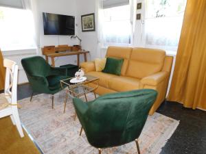 uma sala de estar com um sofá e duas cadeiras em Vali's Paradise em Ptuj