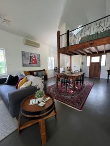 a living room with a couch and a table at Bella Cosa in McLaren Vale