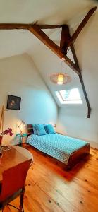 a bedroom with a blue bed in a attic at " Chez Alex " 