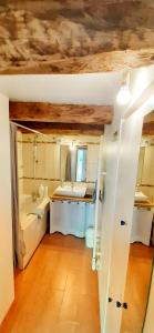a bathroom with a sink and a bath tub at " Chez Alex " 