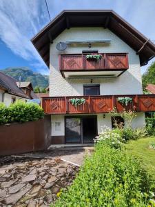 a house with wooden balconies on the side of it at Apartments & wellness Kal Koritnica in Bovec