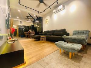 a living room with a couch and chairs and a table at SIX Boutique Residence @ Ipoh Garden Landed House 8pax in Ipoh