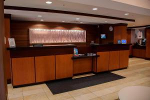 a lobby with a bar in a hotel at Fairfield Inn & Suites Bedford in Bedford