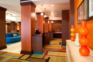 a lobby of a hotel with orange vases on a table at Fairfield Inn & Suites Bedford in Bedford