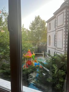 a view of a playground from a window at Herold's Guesthouse in Umraniye