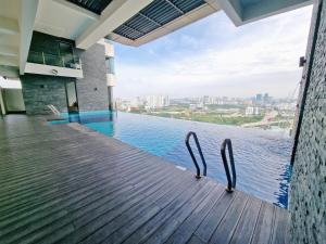 a infinity pool in a building with a view of the water at Lion Home in Seri Kembangan