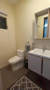 a bathroom with a toilet and a sink and a mirror at Villa Shangri-La in Dumaguete