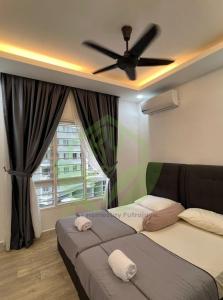 a bedroom with two beds and a ceiling fan at 3R@7pax++ Spacious Space Putrajaya. in Putrajaya