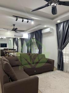 a living room with a couch and a table at 3R@7pax++ Spacious Space Putrajaya. in Putrajaya