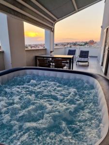 a jacuzzi tub on the balcony of a house at Vila Novak in Novalja