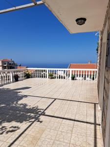 a patio with a view of the ocean from a building at Apartments Dragišić in Sveti Stefan