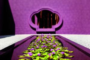 a purple chair with a bunch of purple flowers at Phulay Bay, A Ritz-Carlton Reserve in Tab Kaek Beach +37 photos