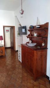 a living room with a large wooden entertainment center at Casa Lenzi in Portoferraio