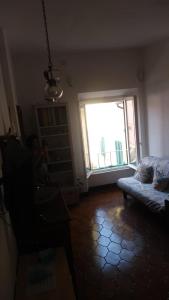 a living room with a couch and a window at Casa Lenzi in Portoferraio
