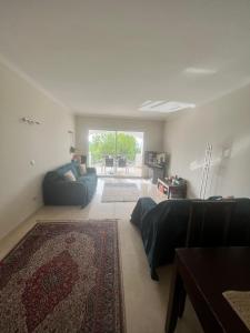 a living room with a couch and a rug at Altos De La Quinta II Apartment Marbella in Marbella