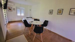 a room with a table and chairs and a bed at Apartman MatiNik1 in Gornja Toplica