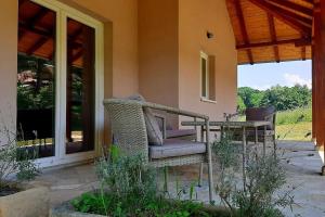 a patio with a table and chairs on a house at Apartman MatiNik1 in Gornja Toplica +7 photos