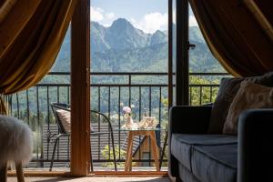 a living room with a view of a mountain at Villa Tatrica in Kościelisko