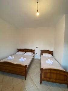 two beds sitting in a room with at VIOLCA GUEST HOUSE in Durrës