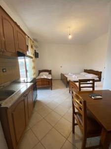 a kitchen and living room with a table and chairs at VIOLCA GUEST HOUSE in Durrës +18 photos