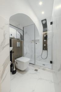 a white bathroom with a shower and a toilet at Odysseus Luxury House in Rhodes Town