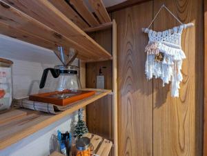 a kitchen with a coffee pot on a shelf at 【豊和マンション稲荷302号室】伏見稲荷駅徒歩３分！Free Wifi付のお宿！ in Kyoto
