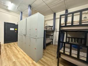 a room with two bunk beds and a closet at Sweed Dee Hostel in Phi Phi Islands