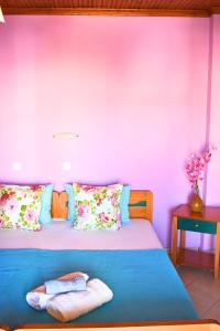 a bedroom with a bed with a purple wall at Studios Centro 6 - 2nd Floor in Potos