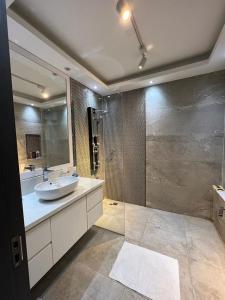 a large bathroom with a sink and a shower at Hurghada marina apartment sea view in Hurghada